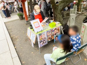 大磯町、六所神社の櫛魂まつりで似顔絵を描いてる様子